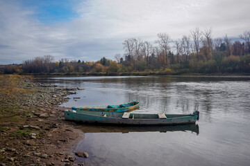 Old wooden fishing boats on Sylva river bank in Molebka © Pavel