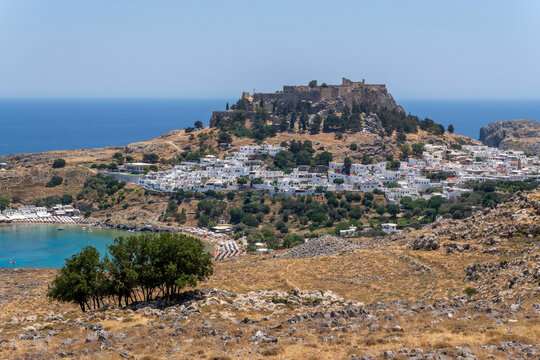 A view of Lindos with the acropolis and the Aegean sea in Greece on a sunny day
