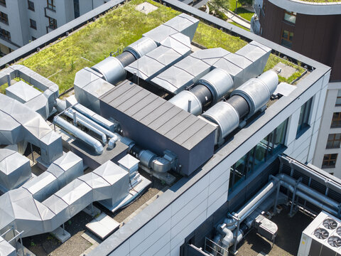 Aerial view of a mechanical ventilation system installed on the green roof of a modern building in Krakow, Poland.