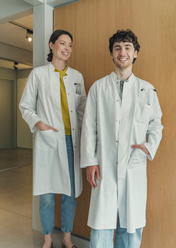 Smiling man and woman doctors wear lab coats in a hospital