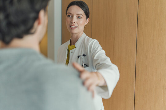 Female doctor comforts male patient during a hospital consultation