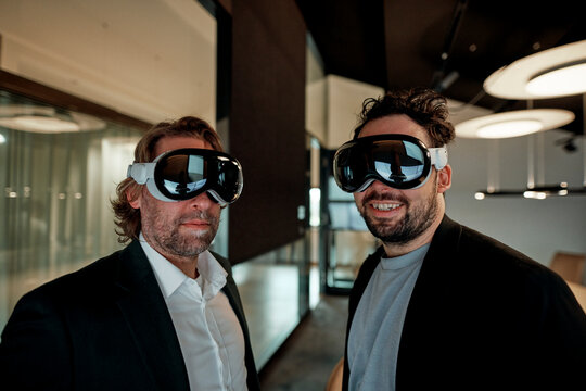 Businessmen wear virtual reality headsets in a smart office