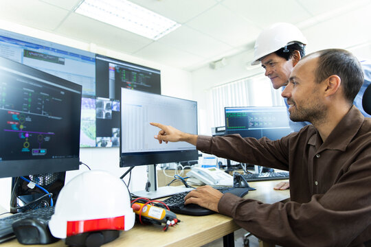 Technicians analyze data in a wind farm control room in Ecuador
