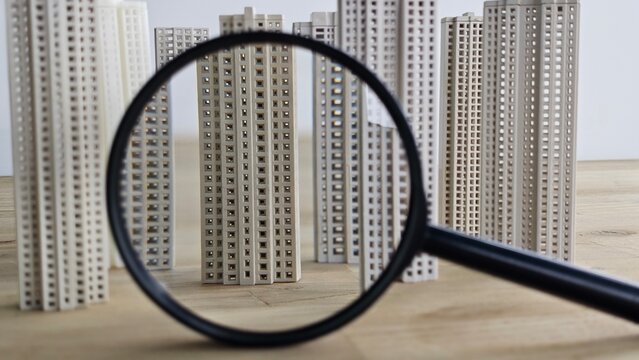Detail of miniature buildings viewed through a magnifying glass placed