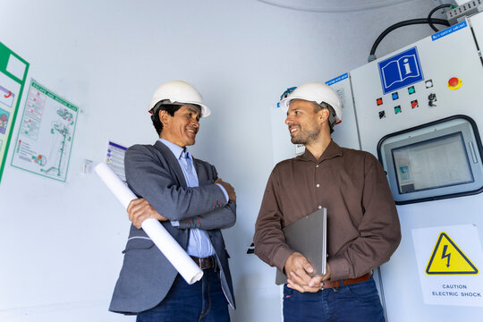 Engineers discuss renewable energy inside a wind turbine facility