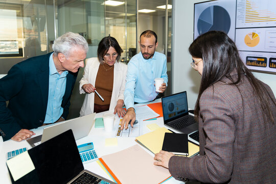 Business colleagues analyze documents during an office meeting