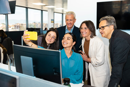Business team takes a fun selfie in the modern office