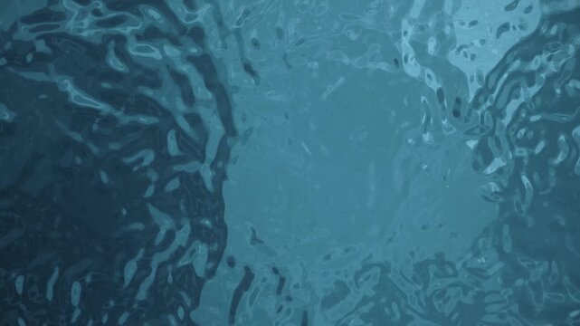 Sunlit water creates shimmering ripples and beautiful blue abstract reflections.