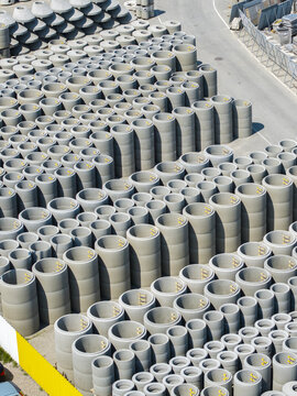 Aerial view of stacks of concrete pipes and manhole sections at the Bruk-Bet manufacturing facility in Poland.