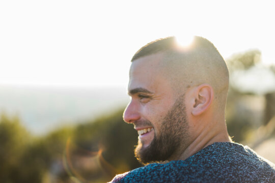 Profile of happy young man in backlight