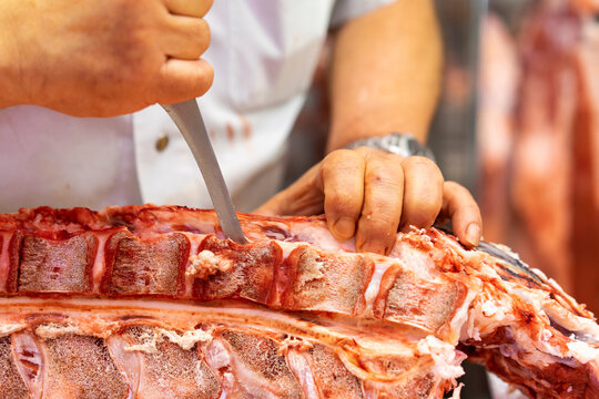 Butcher cutting up pork