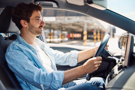 Driver holding steering wheel during a test drive in a parking garage