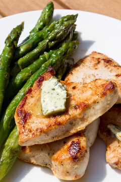 Green asparagus with turkey escalope and herb butter