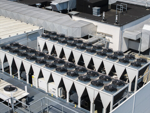 Aerial view of an ai data center rooftop featuring rows of industrial cooling fans and ventilation systems in Krakow, Lesser Poland Voivode, Poland.