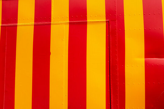 The metal surface displays a red and yellow circus stripe pattern