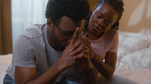 African American couple solving relationship conflict at home bedroom wife apologizing comforting sad upset husband after quarrel argument asking forgiveness love psychology marriage family evening