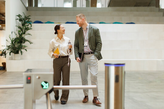 Smiling businessman and businesswoman discuss work in the office
