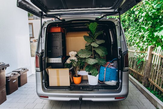 Moving van loaded with houseplants and belongings on relocation day
