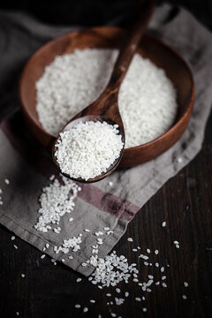 Wooden spoon with risotto rice in a bowl