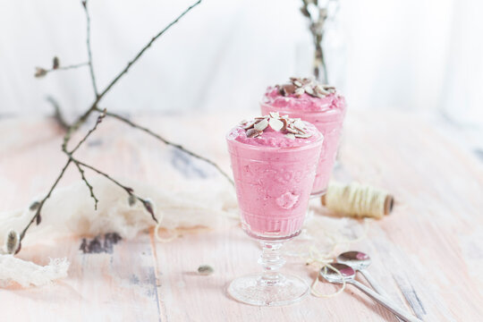 Two glasses of raspberry mousse with chocolate crumbs