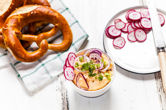 Obatzda with red onion, radish, spring onion and pretzel