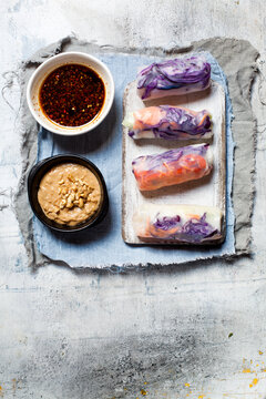 Vegan rice paper wraps (vietnamese summer rolls), filled with cabbage, carrots, bell pepper, rice noodles and dipping sauce