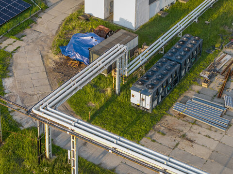Aerial view of technical installations at the Wieliczka Salt Mine with industrial cooling units, metal piping, and solar panels in Wieliczka, Lesser Poland Voivode, Poland.