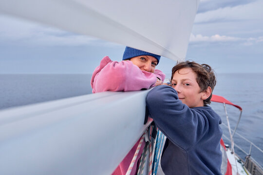 Mother and teenage son sail a boat on the Adriatic Sea
