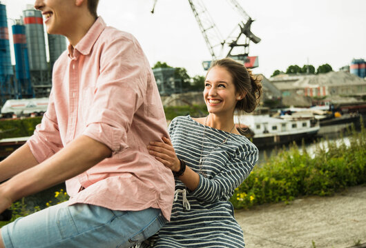 Young couple driving together on bicycle