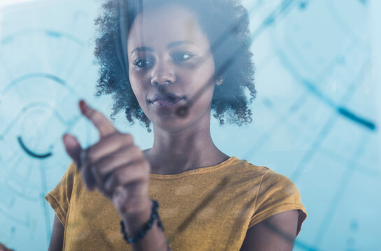 Young woman using transparent touchscreen display