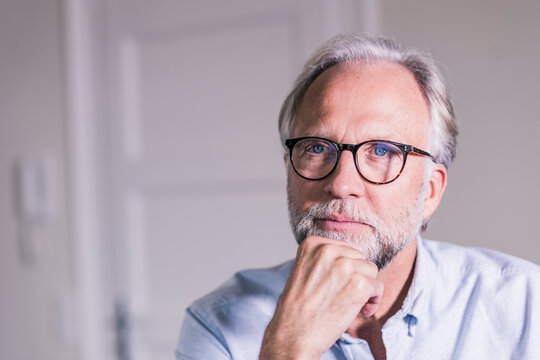 Portrait of pansive mature man wearing glasses