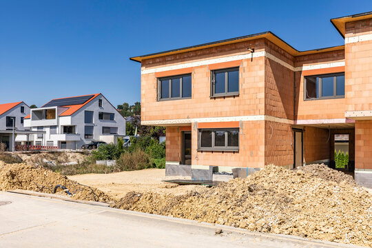 Germany, Bavaria, Elchingen, Freshly dug dirt in front of brick suburban house