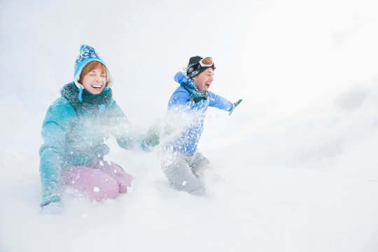 Italy, South Tyrol, Seiseralm, Couple fooling about in snow