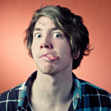Man making sticking out tongue, portrait