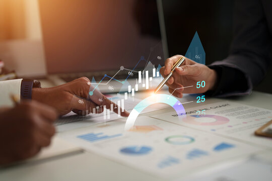 Business executives analyzing financial charts and digital growth data in corporate meeting