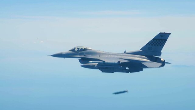 U.S. Air Force F-16 Fighting Falcon releases precision-guided munition during high-altitude combat training mission over open skies.