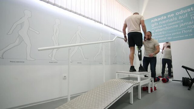 Rehabilitation specialist assists to amputee man 