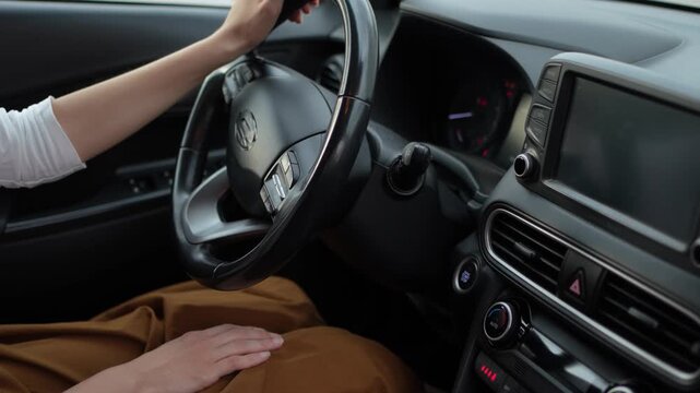 Female driver starting a car