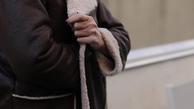 hands appreciating the feel of the coat