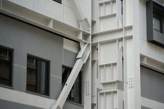 A steel seismic brace installed on a modern building exterior.
