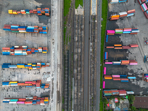 Aerial view of colorful shipping containers arranged in rows at a busy rail yard in Dhaka, Dhaka Division, Bangladesh.
