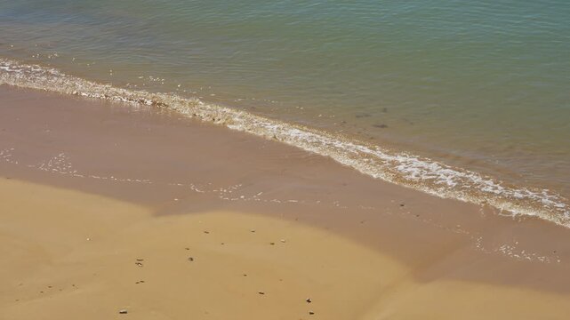 Calm ocean waves at a beach in Chipiona, Cadiz