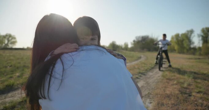 Children spend time with mother enjoying nature. 4K 10-bit