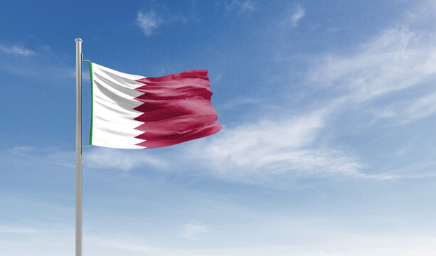 Qatar national flag waving in the sky.