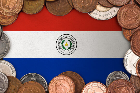 Coins on flag of Paraguay trading investment business currency concept
