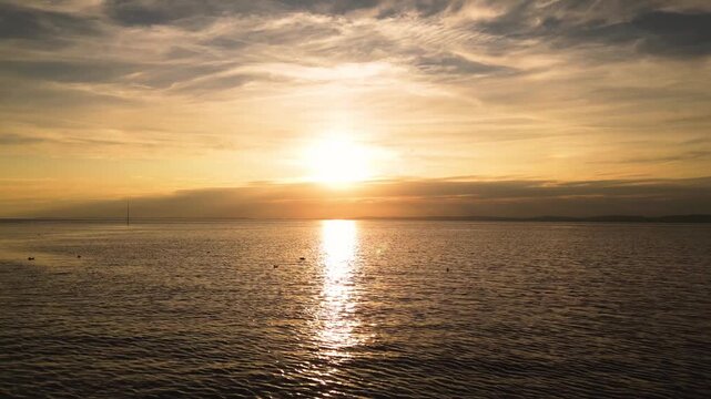 Aerial view of calm sea and coastline at sunset near Clevedon, Somerset