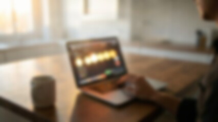 Obraz premium defocused person working on laptop with warm light for fintech