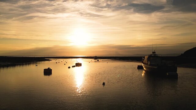 Golden hour aerial footage of boats and seabirds in Somerset