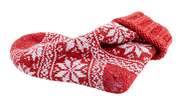 Red and white knitted sock with snowflake pattern
