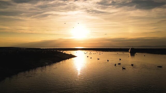 Drone footage of boats and birds at sunset in Clevedon Harbour
